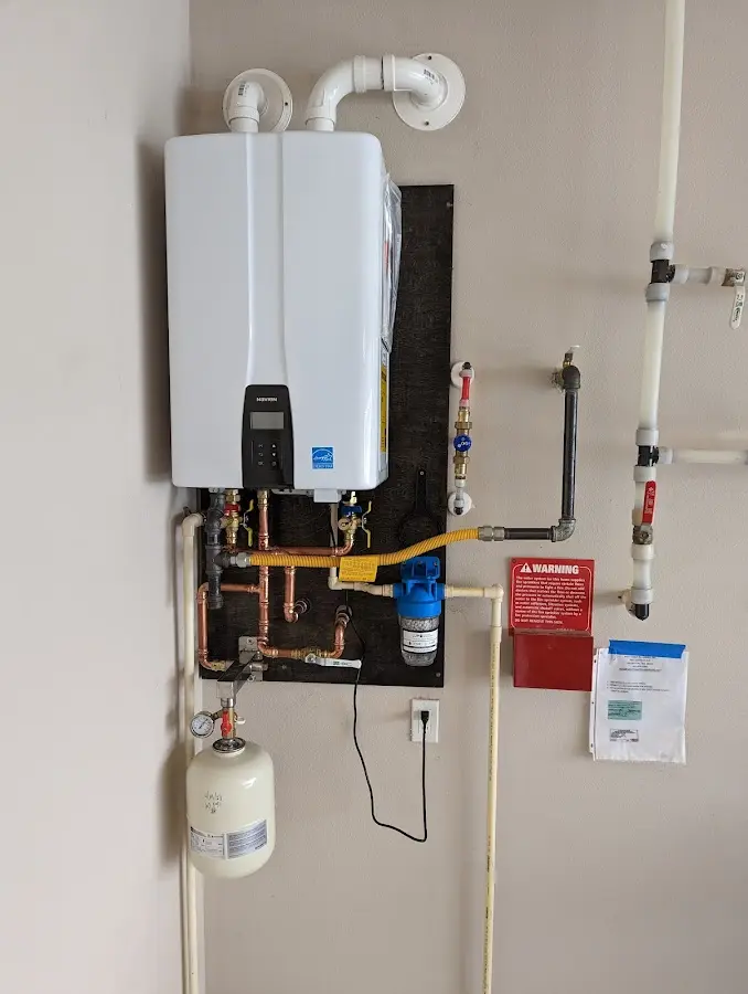 Professional plumber installing copper piping in a Santa Clara home